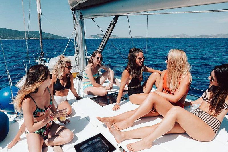 Friends relaxing together on the deck of a sailboat